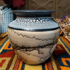 This distinctive Horsehair Pottery by Roger Calhoun features a rounded ceramic vessel with natural earth tones, delicate black horsehair patterns, a decorative crackled upper section, and a wide black rim.