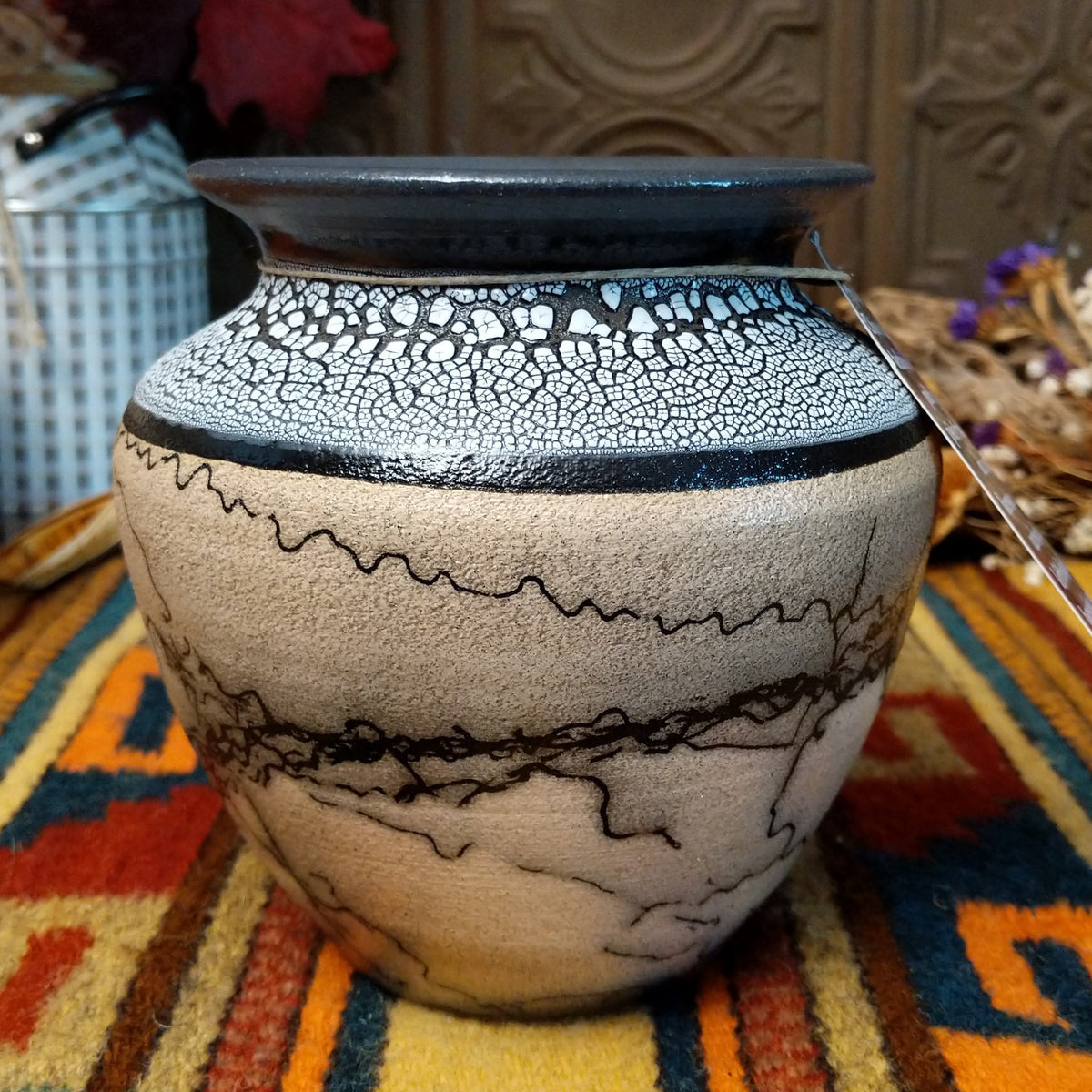 This distinctive Horsehair Pottery by Roger Calhoun features a rounded ceramic vessel with natural earth tones, delicate black horsehair patterns, a decorative crackled upper section, and a wide black rim.