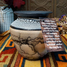 This distinctive Horsehair Pottery by Roger Calhoun features a rounded ceramic vessel with natural earth tones, delicate black horsehair patterns, a decorative crackled upper section, and a wide black rim.