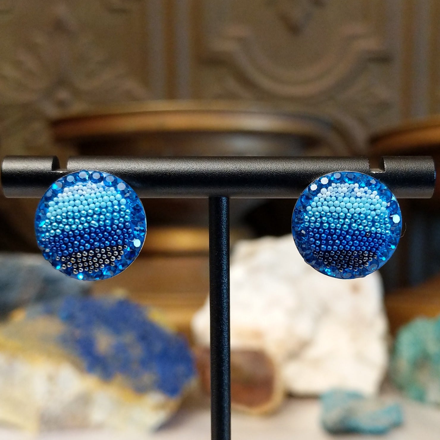 Sterling silver circular earrings with blue Austrian crystals.