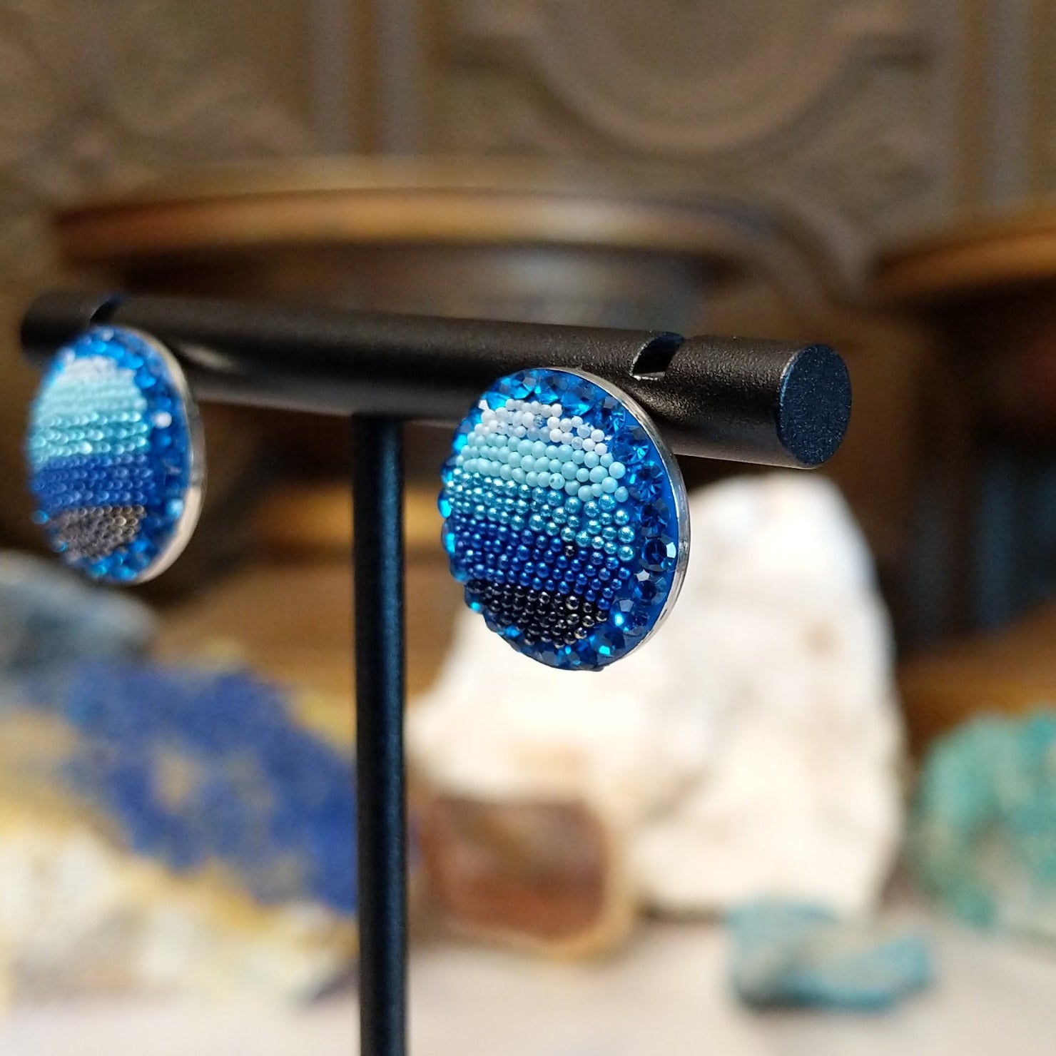 Sterling silver circular earrings with blue Austrian crystals.