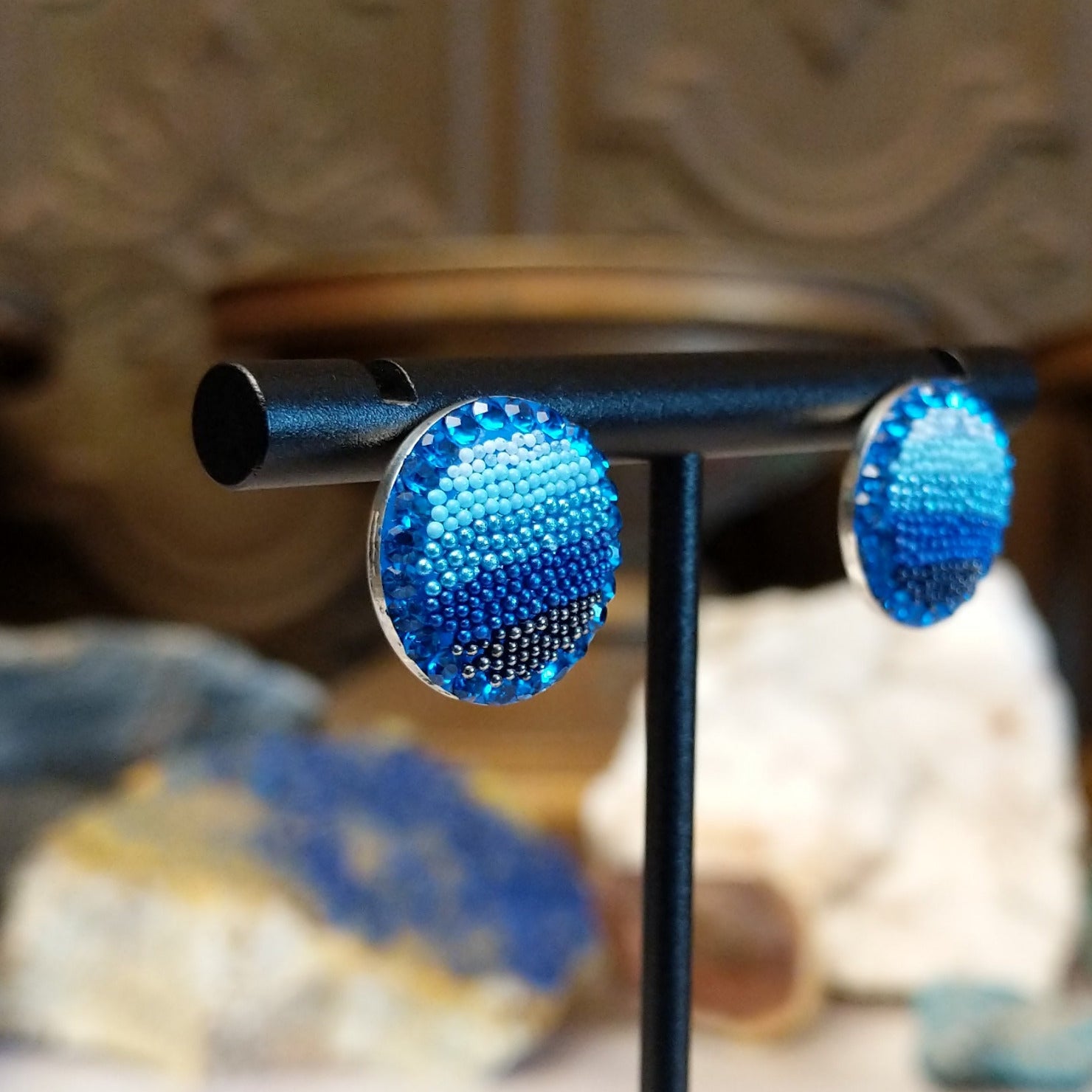 Sterling silver circular earrings with blue Austrian crystals.