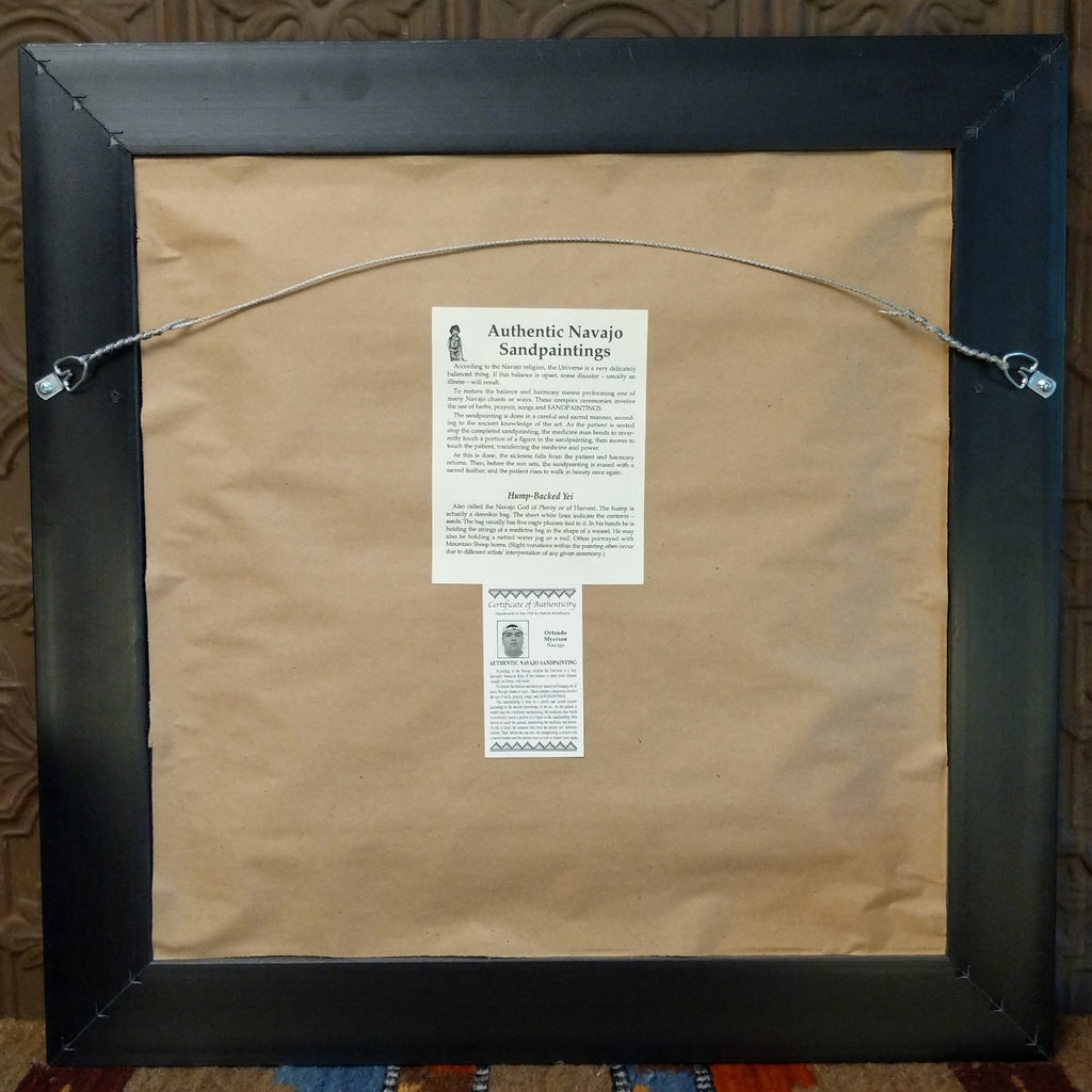 The back features a wire hook and authentication tag.