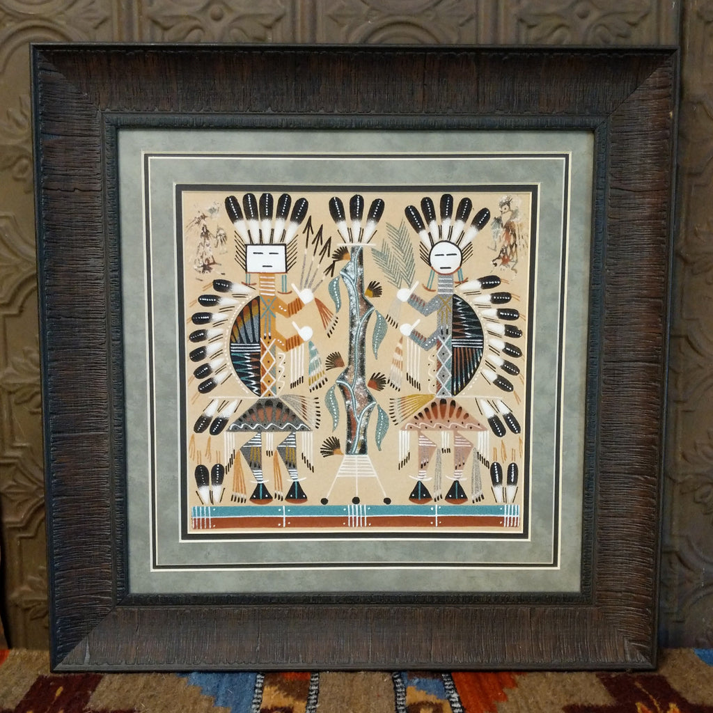 Sand used to depict the Hump-backed Yei set within a dark, wooden frame.