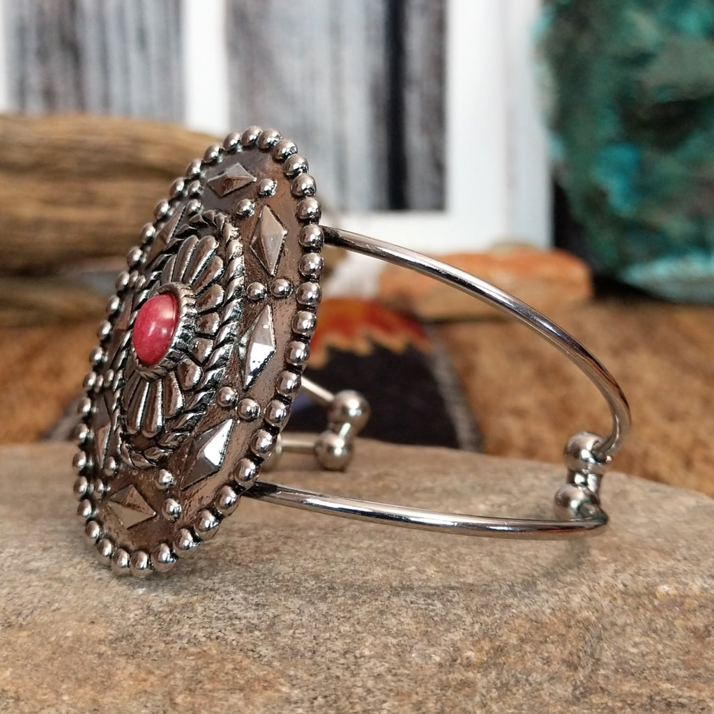 Nickel-free metal bracelet with a red stone center and thin dual band.