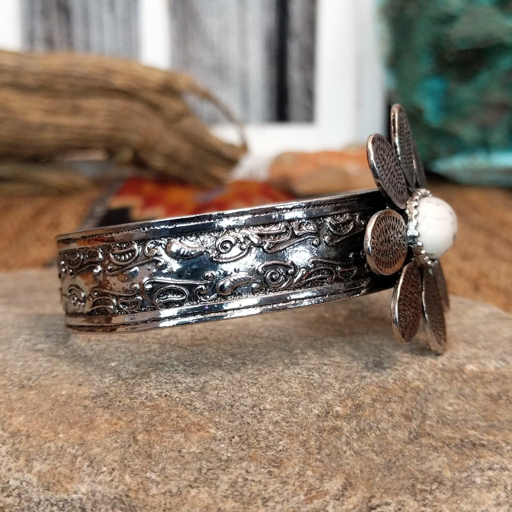 Nickel-free metal bracelet with a white stone center and etched band accents.