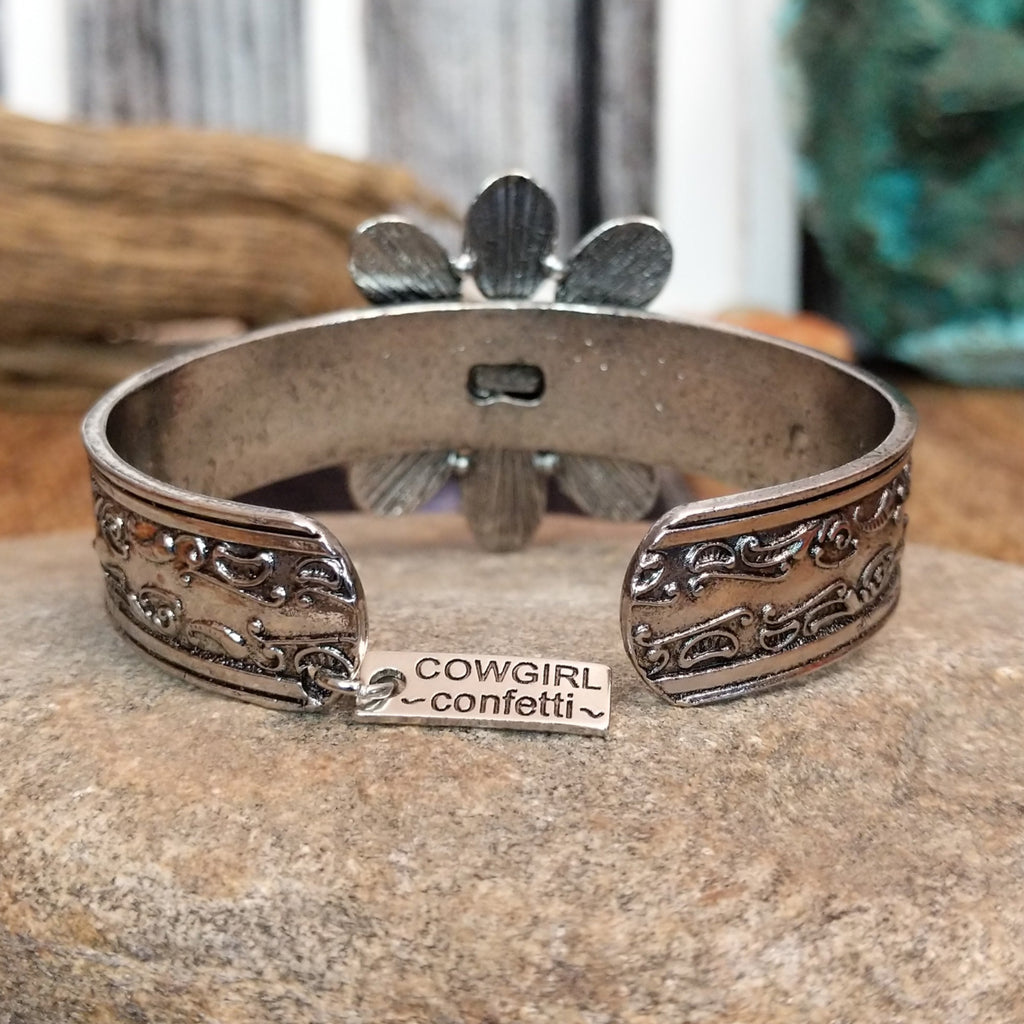Cowgirl Confetti maker's tag is set on a charm at the tail of the bracelet.