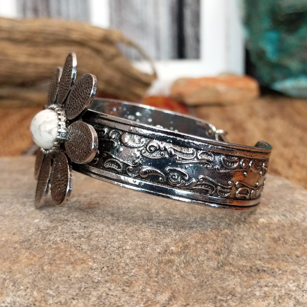 Nickel-free metal bracelet with a white stone center and etched band accents.