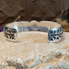 Sterling silver cuff with Sonoran gold turquoise set in an oval bezel and floral stamping along the surface of the band.