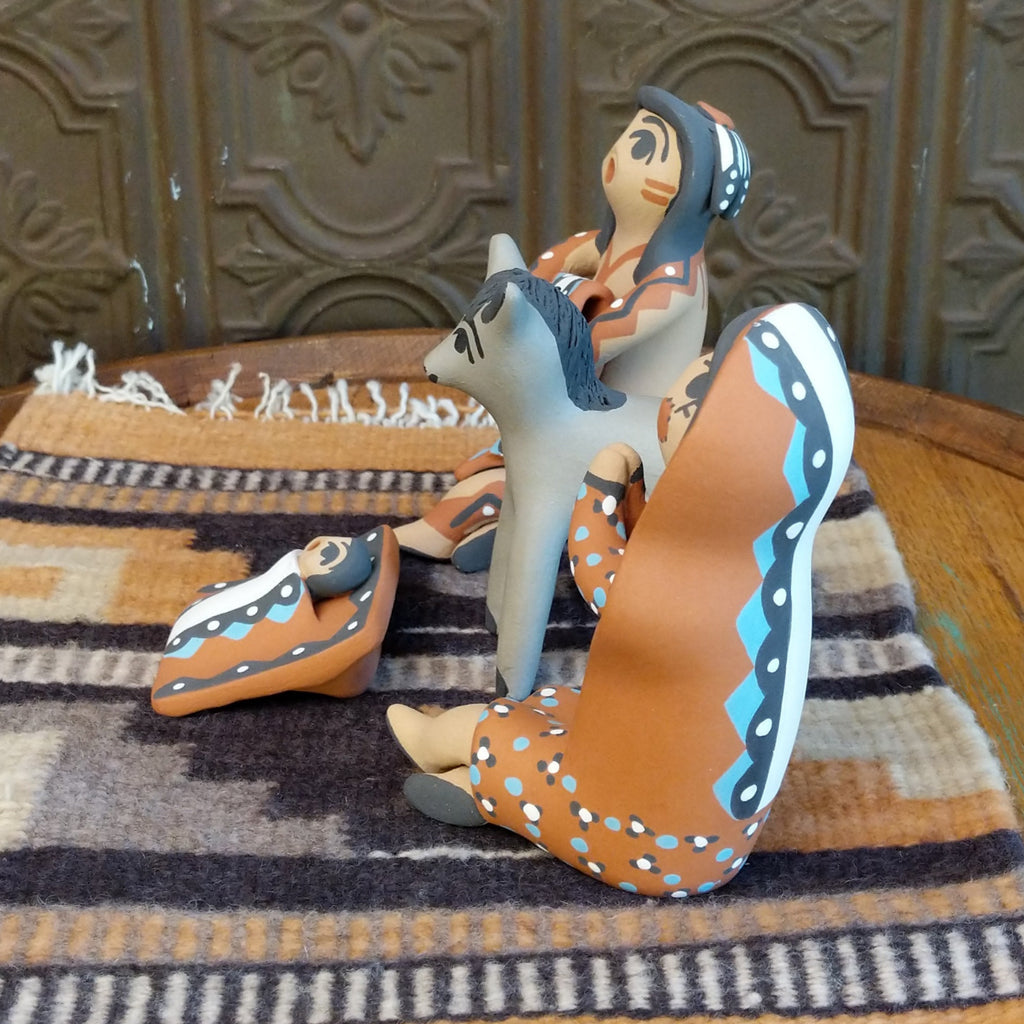 Clay made into a mother, father, baby, and donkey and are painted in various colorful designs.