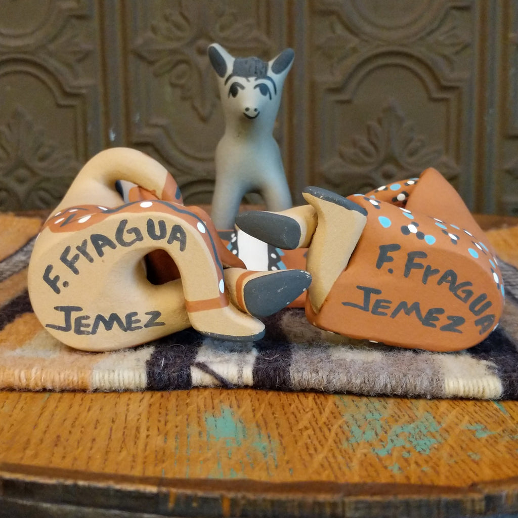 The artisan's signature is found at the bottom of the piece.