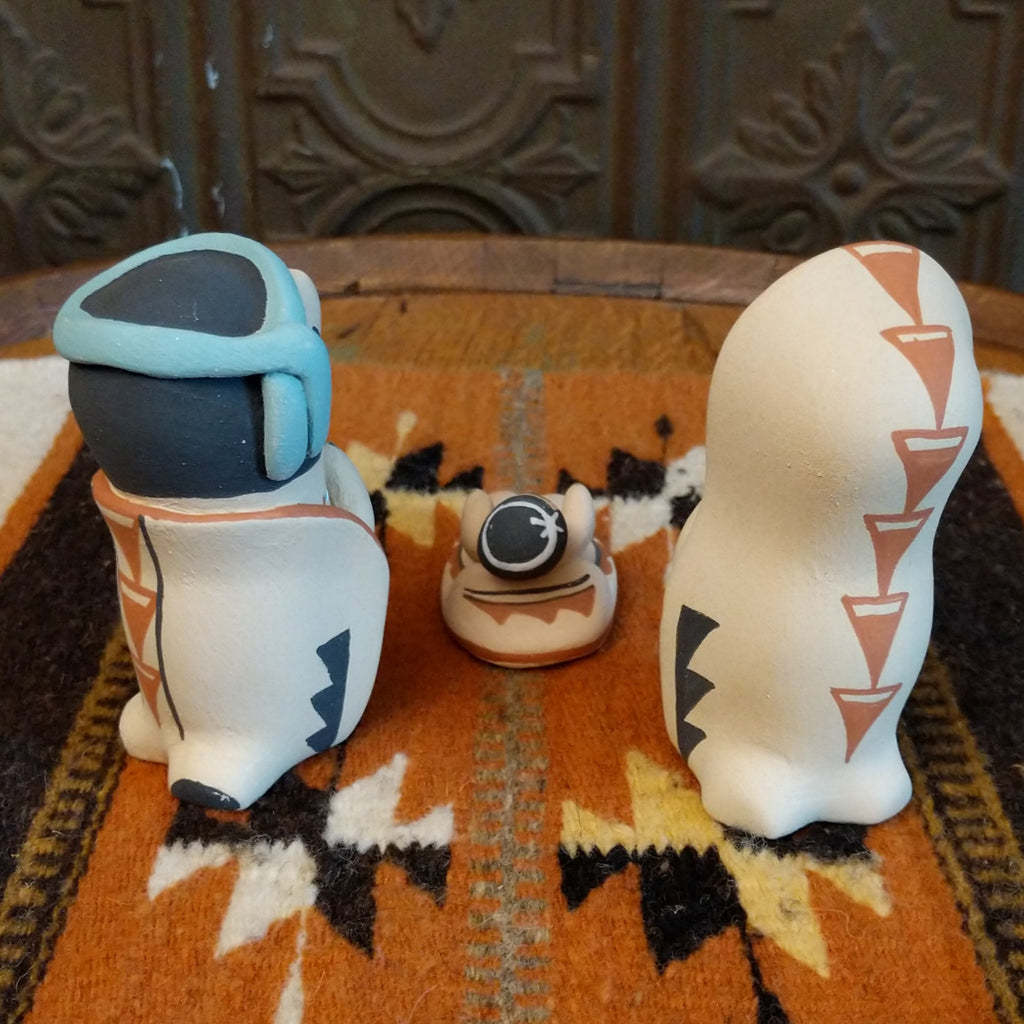 Clay sculpted into a small nativity scene and painted in the colors black, white, blue, and terracotta.