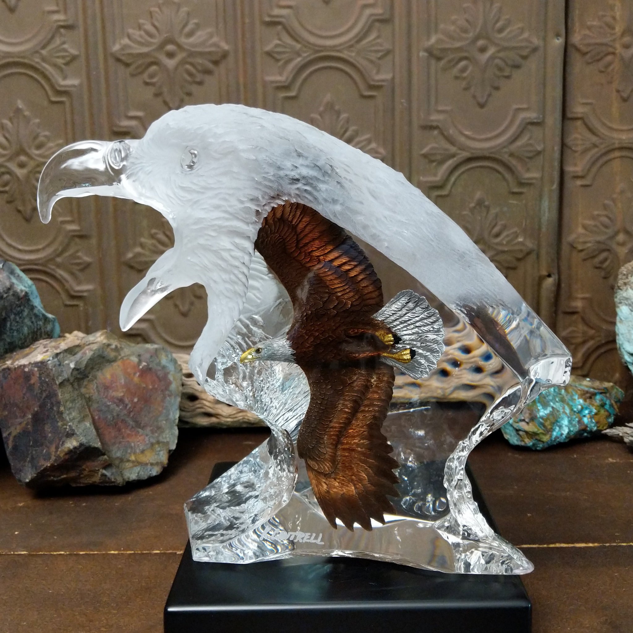 A frosted Lucite sculpture of a bald eagle with a hand-painted bald eagle soaring through the clear crystal interior.