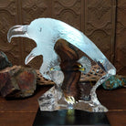 A frosted Lucite sculpture of a bald eagle with a hand-painted bald eagle soaring through the clear crystal interior; low light display.