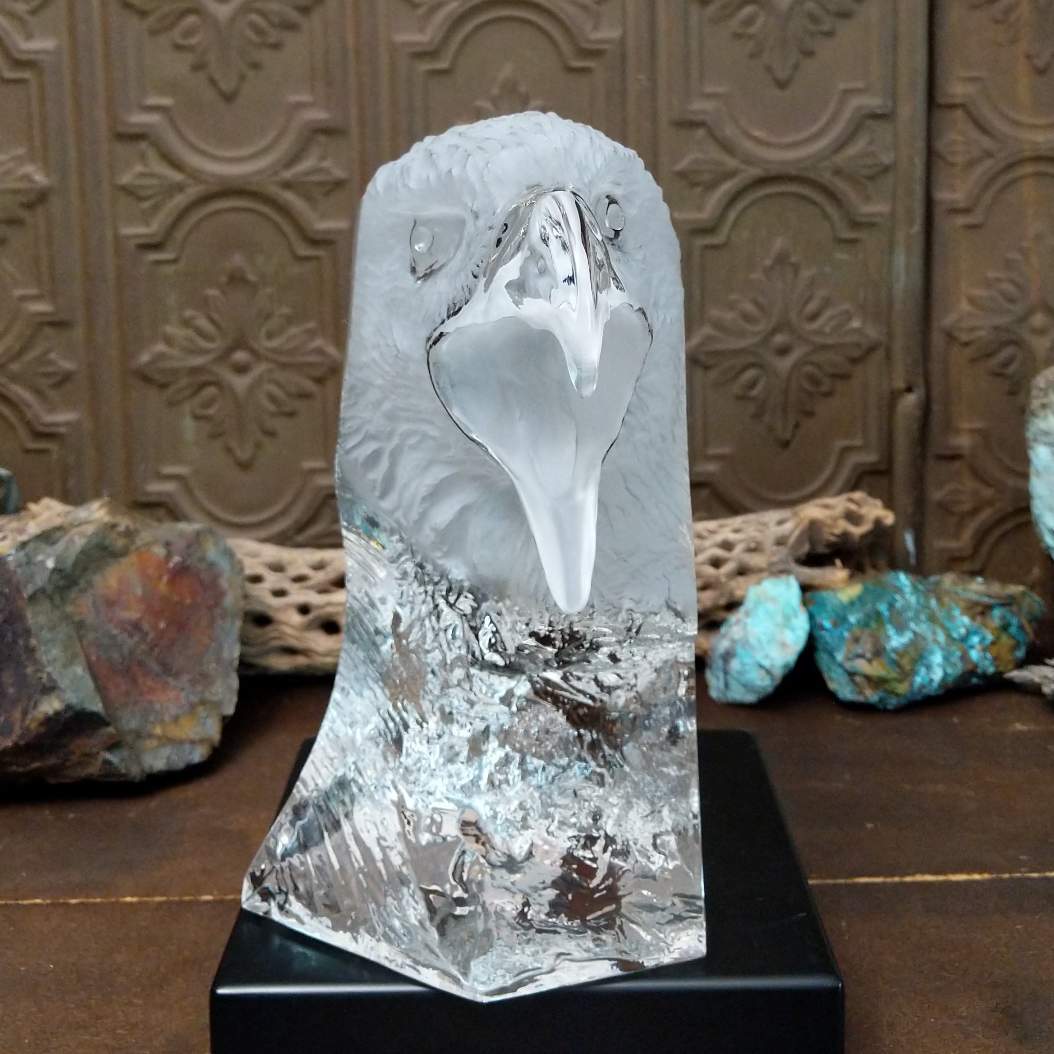 A frosted Lucite sculpture of a bald eagle with a hand-painted bald eagle soaring through the clear crystal interior.