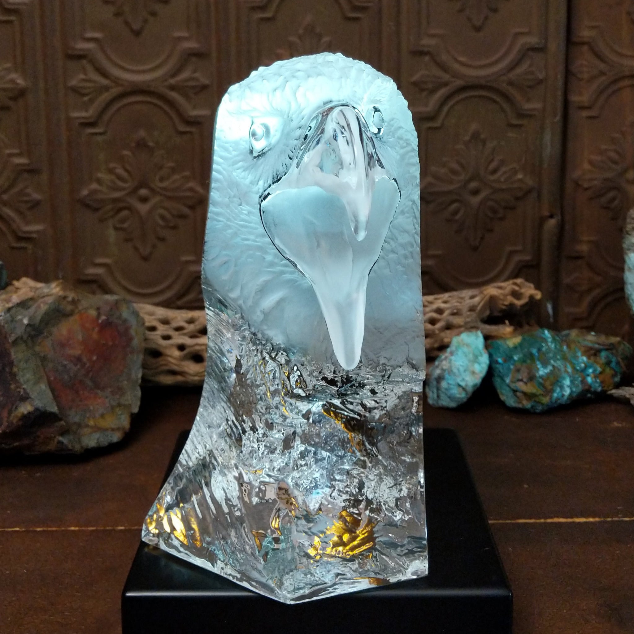 A frosted Lucite sculpture of a bald eagle with a hand-painted bald eagle soaring through the clear crystal interior; low light display.