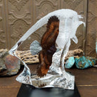 A frosted Lucite sculpture of a bald eagle with a hand-painted bald eagle soaring through the clear crystal interior.