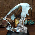 A frosted Lucite sculpture of a bald eagle with a hand-painted bald eagle soaring through the clear crystal interior; low light display.
