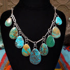 Kingman, Royston, and Boulder turquoise necklace by Everett and Mary Teller with nine teardrop-shaped stones on handmade silver links.