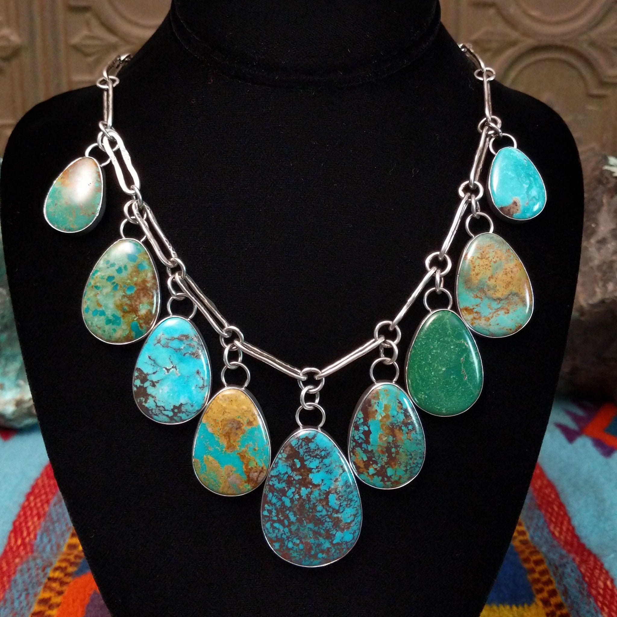 Kingman, Royston, and Boulder turquoise necklace by Everett and Mary Teller with nine teardrop-shaped stones on handmade silver links.