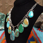 Kingman, Royston, and Boulder turquoise necklace by Everett and Mary Teller with nine teardrop-shaped stones on handmade silver links.