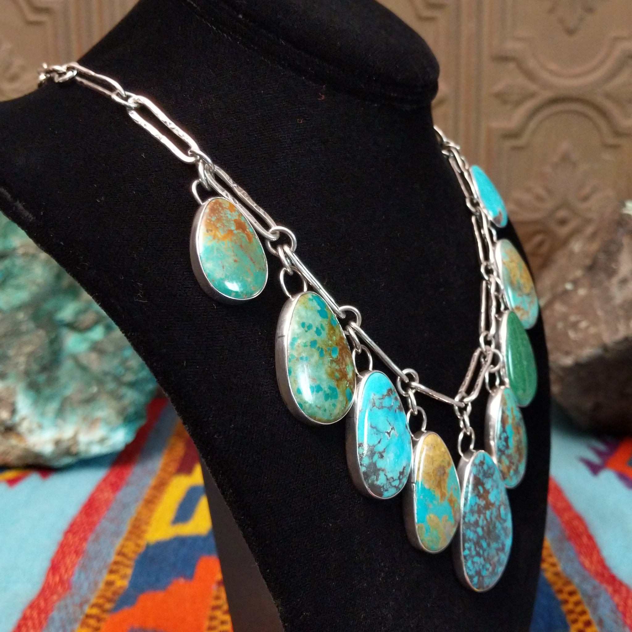 Kingman, Royston, and Boulder turquoise necklace by Everett and Mary Teller with nine teardrop-shaped stones on handmade silver links.