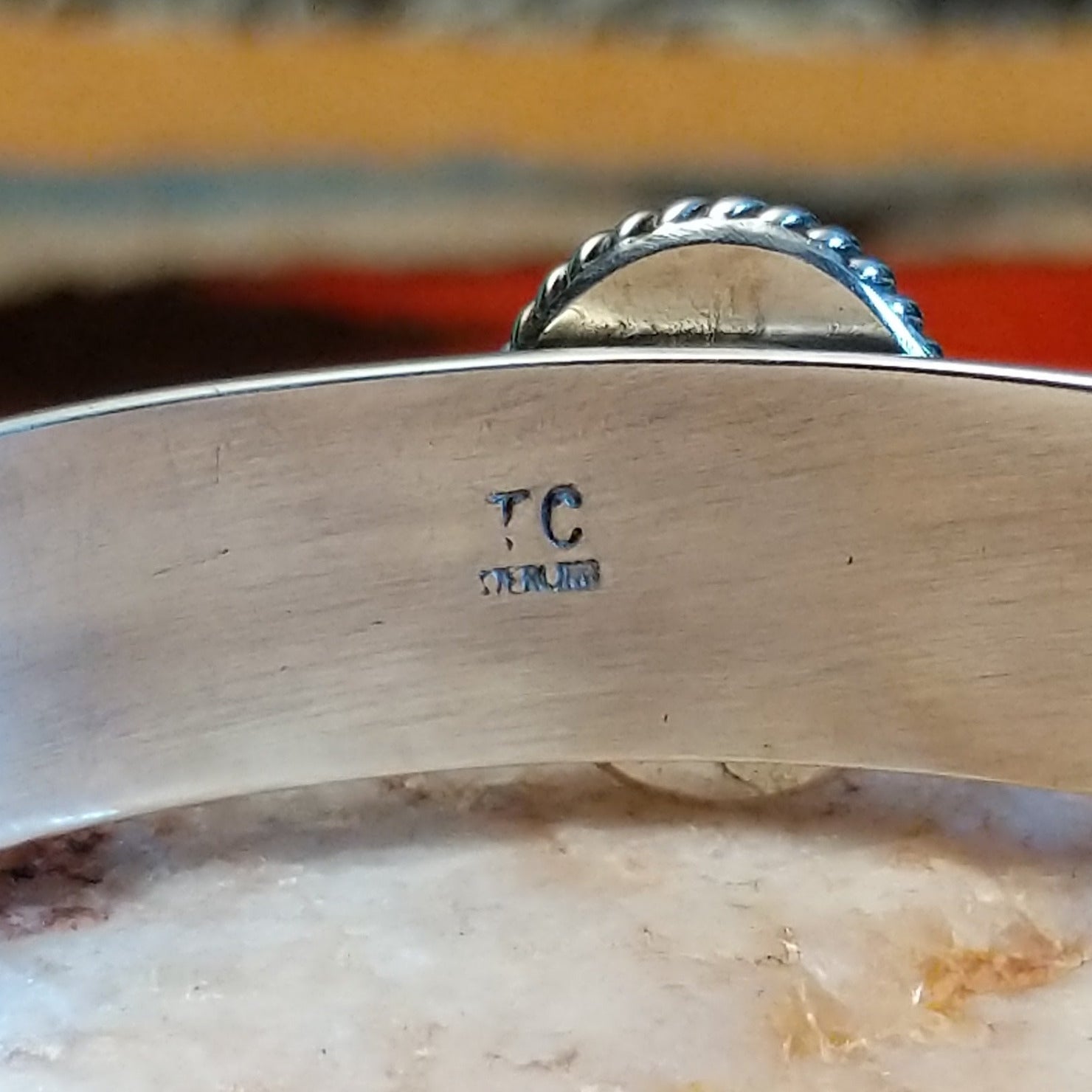 Close-up of the artisan's stamped signature.