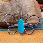 Sterling silver butterfly pendant with Kingman turquoise set in the oval bezel.