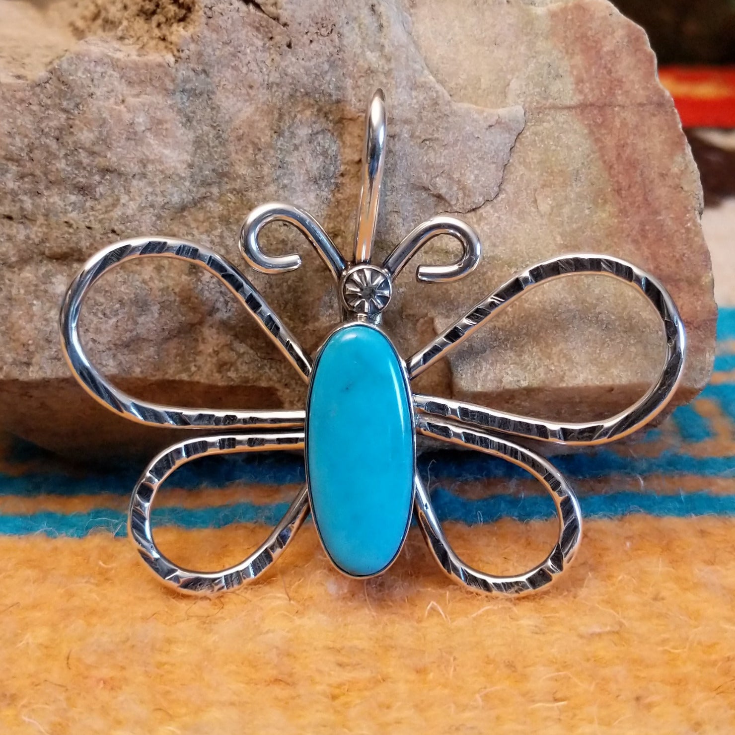 Sterling silver butterfly pendant with Kingman turquoise set in the oval bezel.