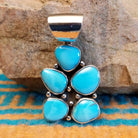 Sterling silver pendant with Kingman turquoise set in cluster bezels.