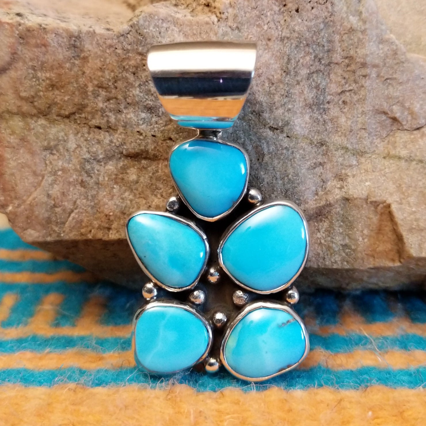 Sterling silver pendant with Kingman turquoise set in cluster bezels.
