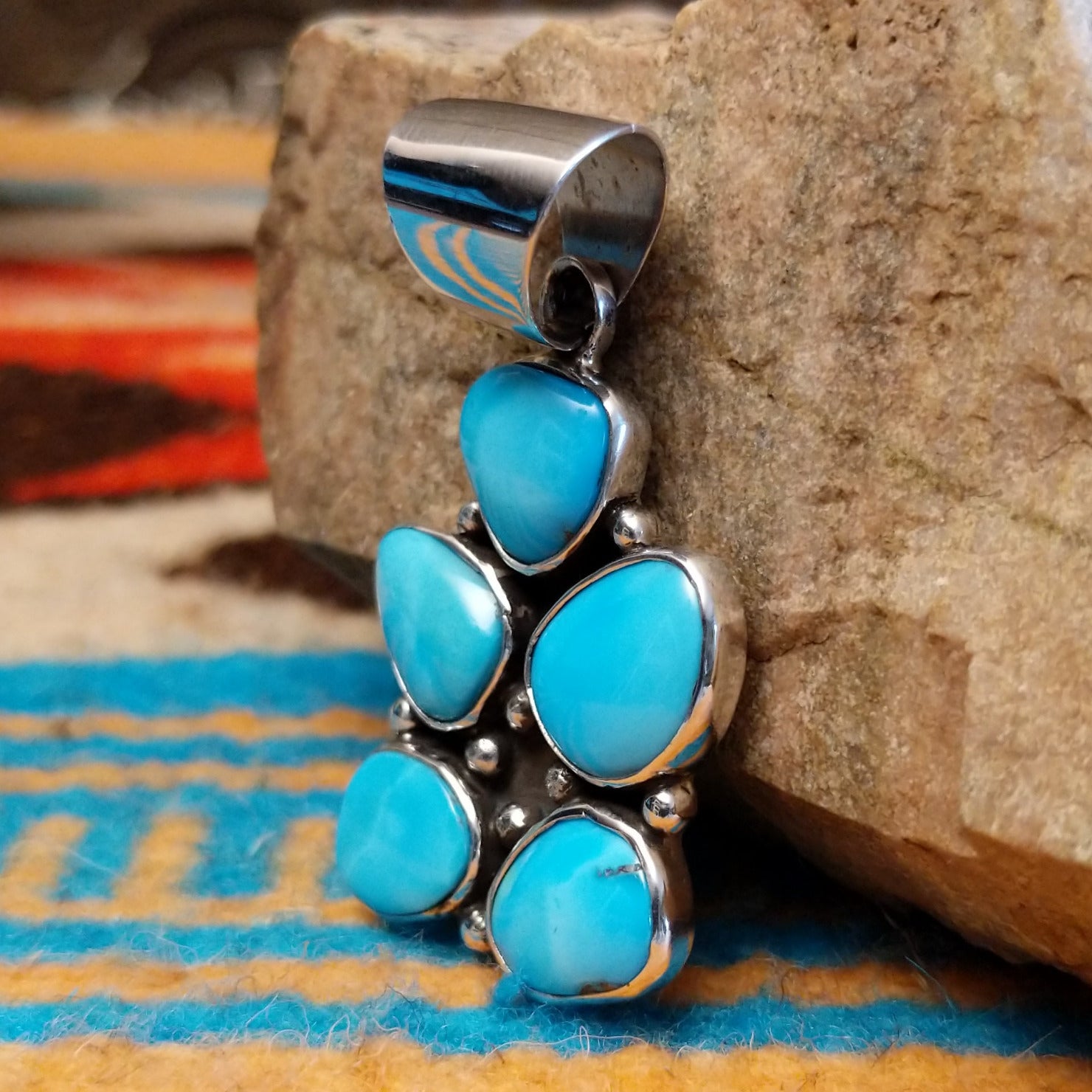 Sterling silver pendant with Kingman turquoise set in cluster bezels.