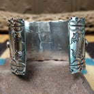 Kingman turquoise cuff by Betty A. Lee featuring a natural blue turquoise stone on a wide hand-stamped sterling silver cuff; underside view.