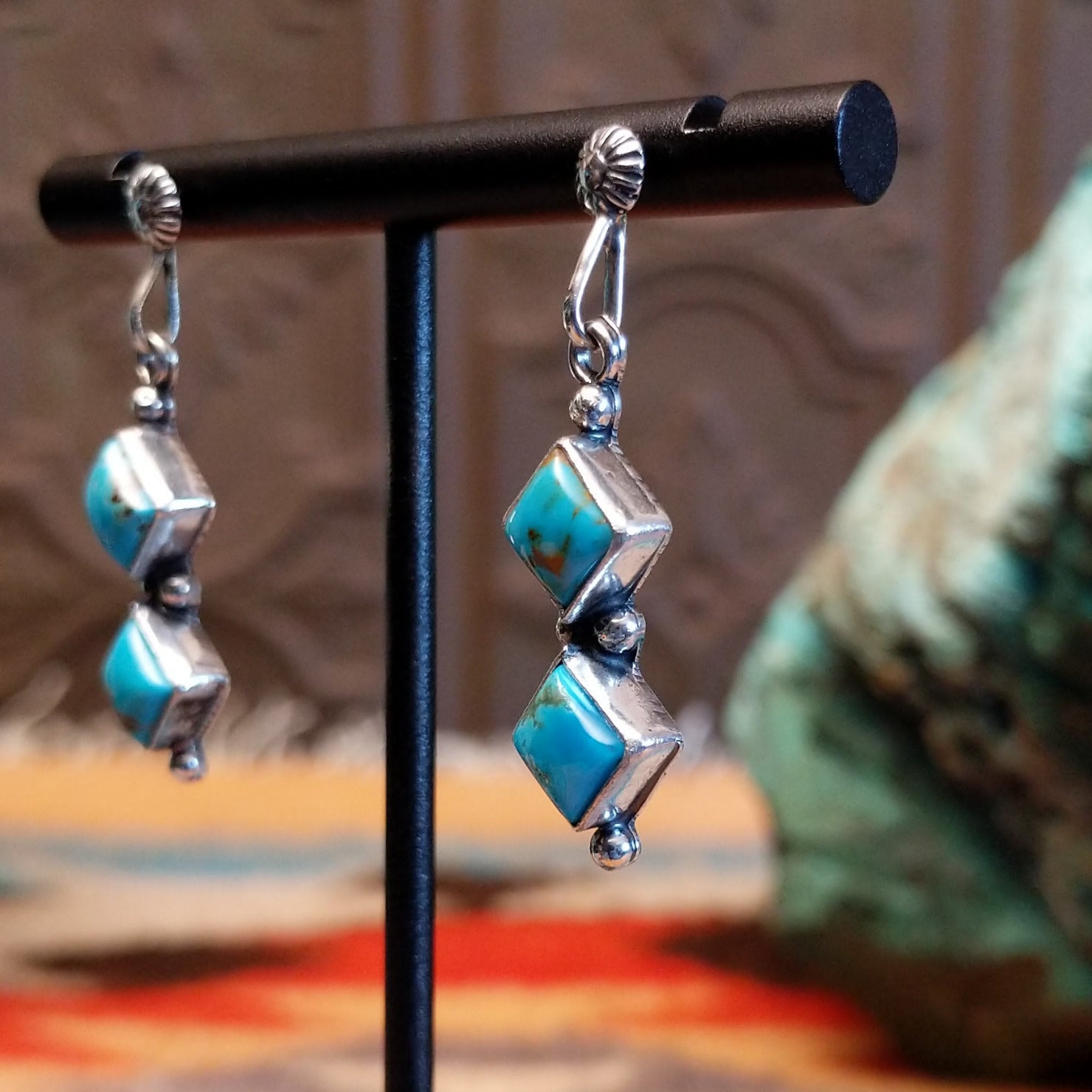 Sterling silver dangle earrings with Kingman turquoise set in the diamond-shaped bezels.