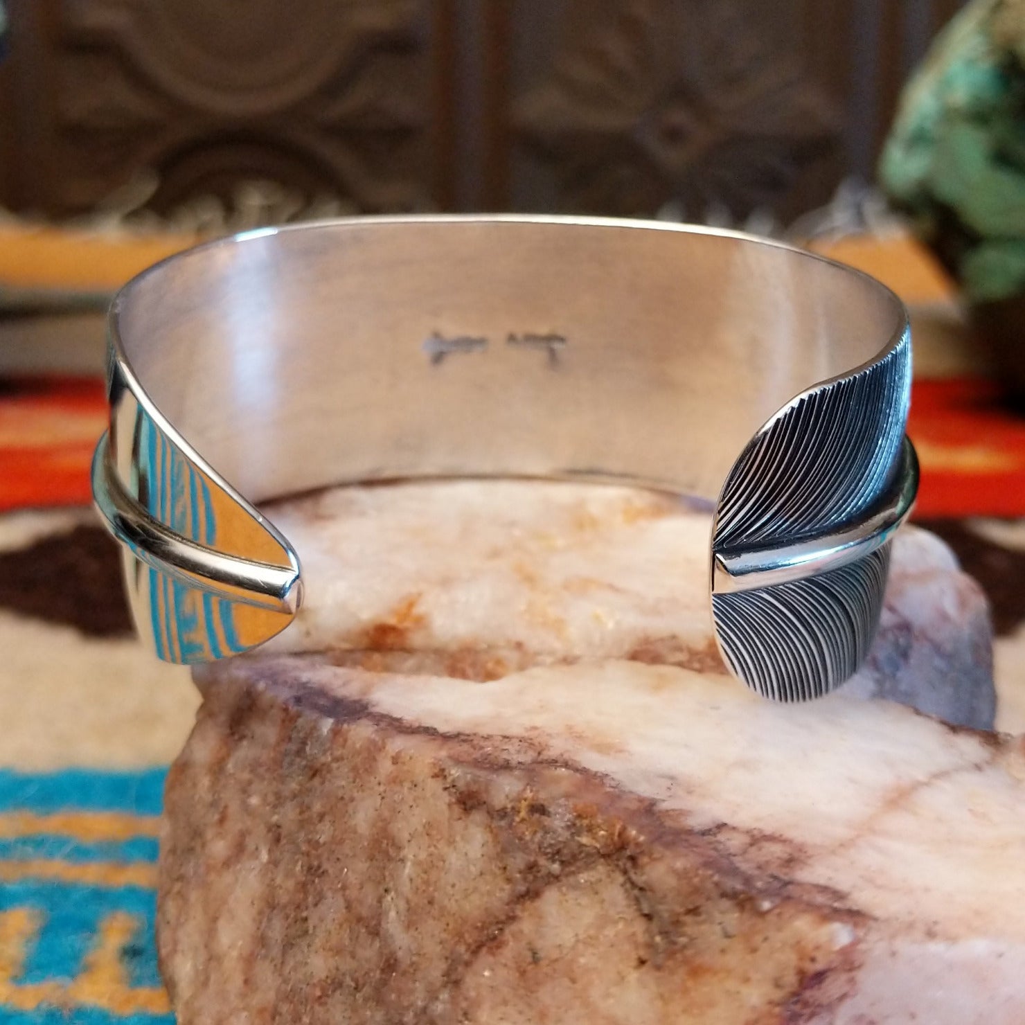 Sterling silver cuff bracelet with Kingman turquoise set in an oval bezel and feather band design.