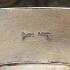 Close-up of the artisan's stamped signature.