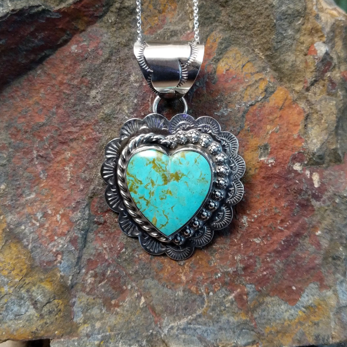 with golden-brown matrix surrounded by ornate sterling silverwork.
