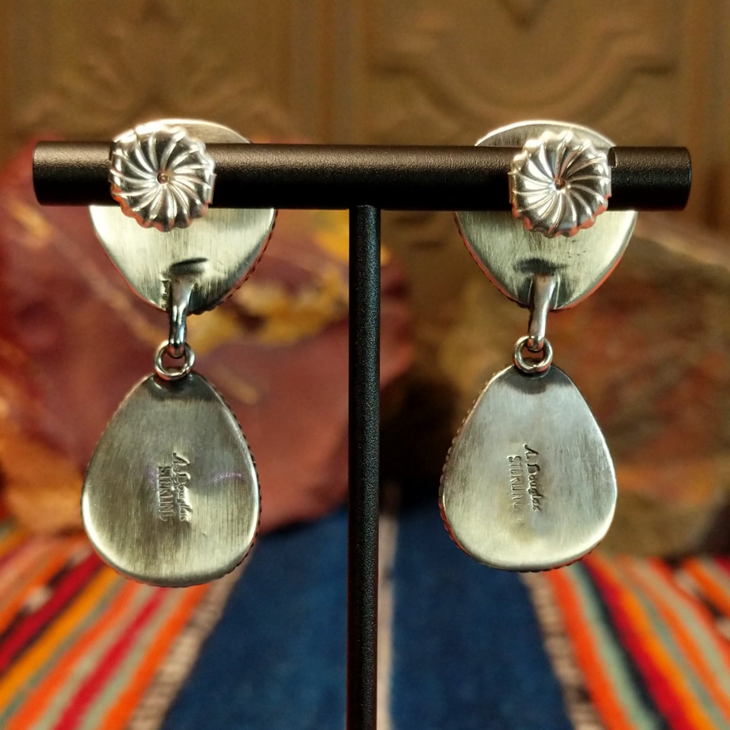 The artisan's signature is found on the back of the earrings.