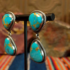 Two Kingman turquoise stones set in twisted rope bezels forming the drop earrings.
