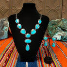 Kingman turquoise set in twisted rope bezels linked together to form a necklace with matching earrings.