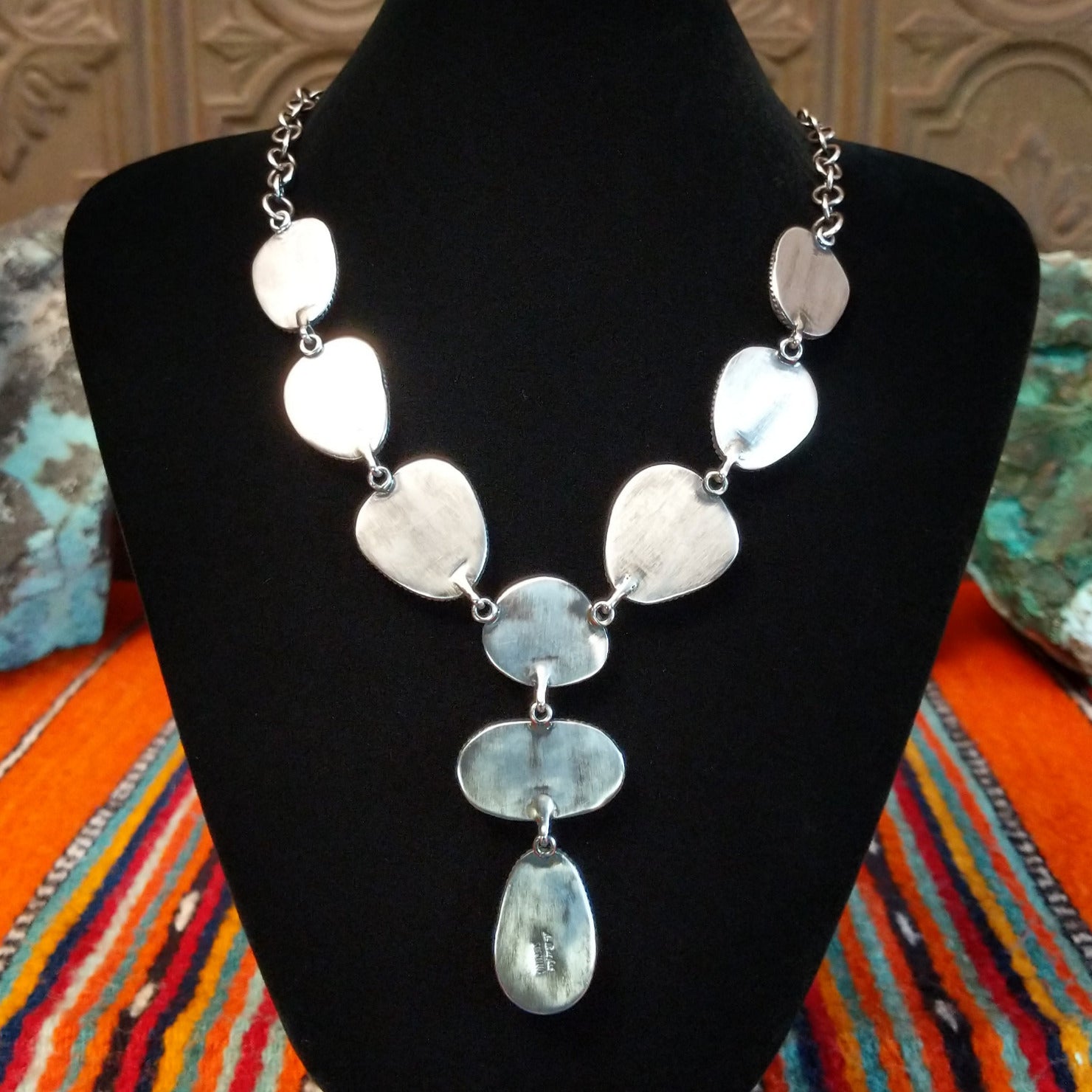 The back of the necklace features the smooth sterling silver.