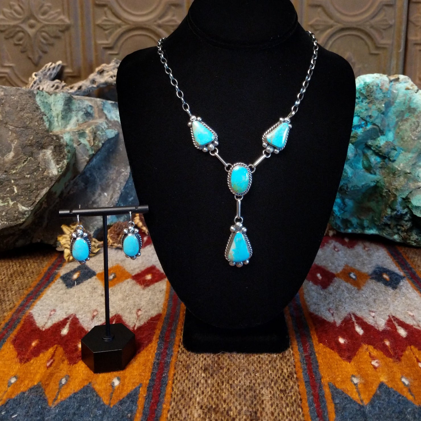 Sterling silver necklace and earring set with kingman turquoise set in the bezels, framed by twisted rope and dotted accents.