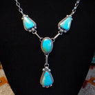Sterling silver necklace with kingman turquoise set in the bezels, framed by twisted rope and dotted accents.