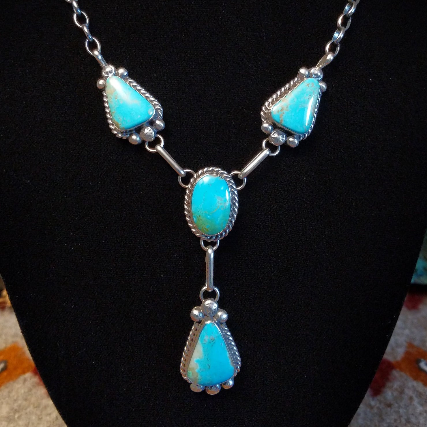 Sterling silver necklace with kingman turquoise set in the bezels, framed by twisted rope and dotted accents.