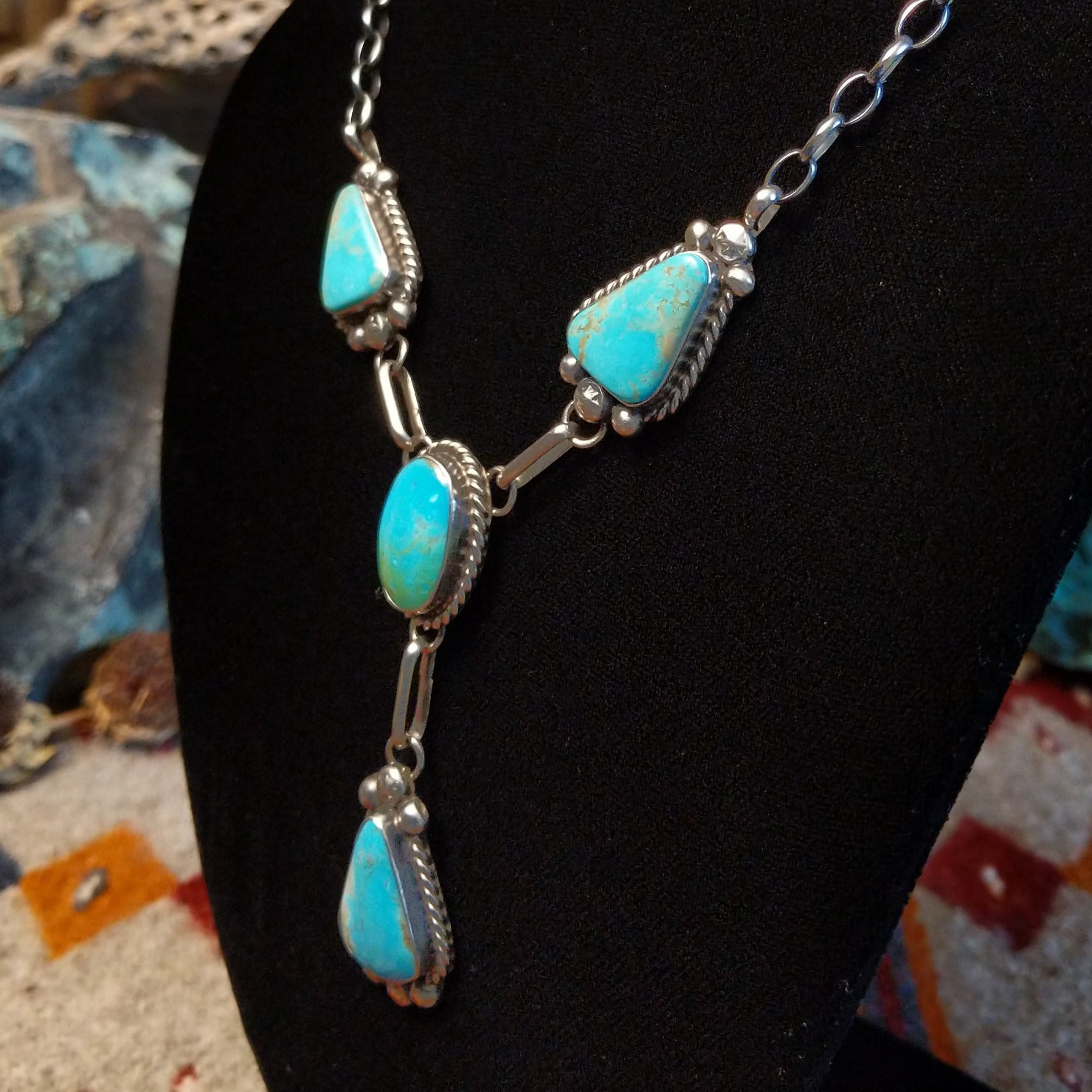 Sterling silver necklace with kingman turquoise set in the bezels, framed by twisted rope and dotted accents.