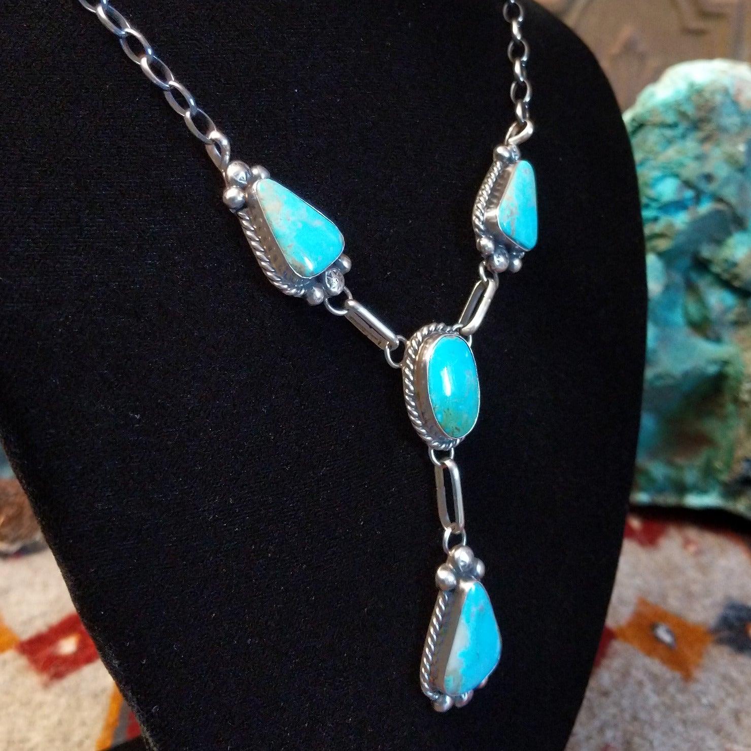 Sterling silver necklace with kingman turquoise set in the bezels, framed by twisted rope and dotted accents.