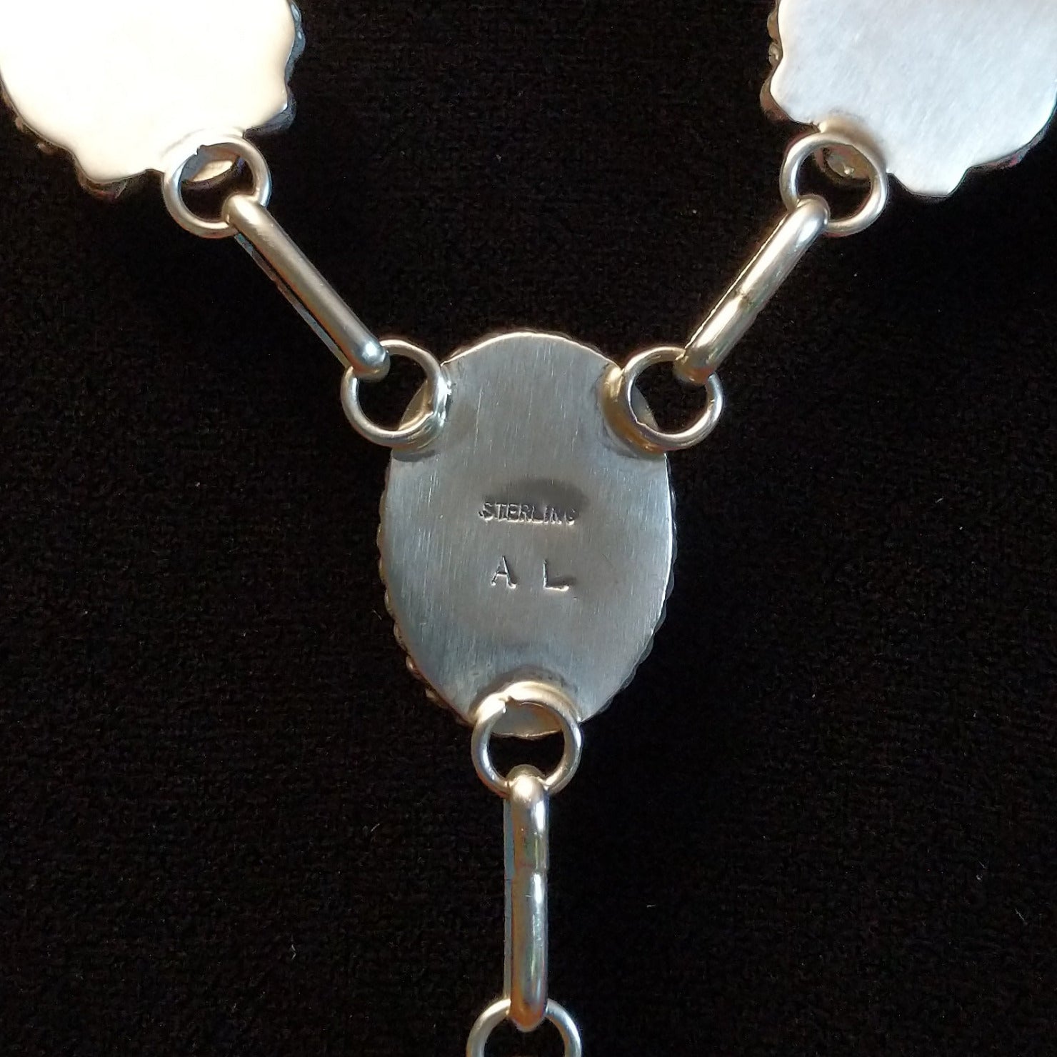 Close-up of the artisan's stamped initials.