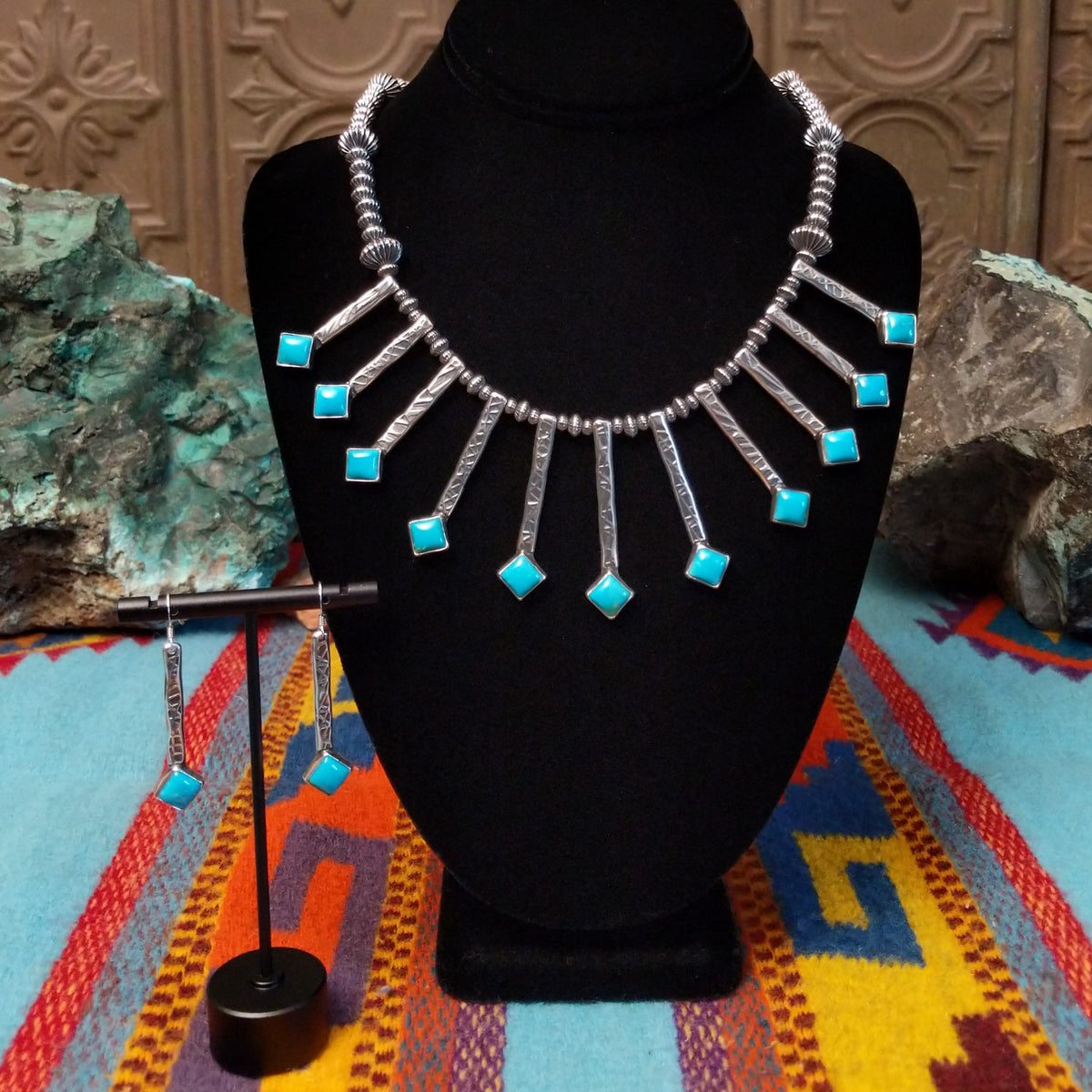 Everett & Mary Teller Kingman Turquoise necklace and matching earrings featuring vibrant turquoise stones, stamped Sterling Silver drops, and decorative silver beads.