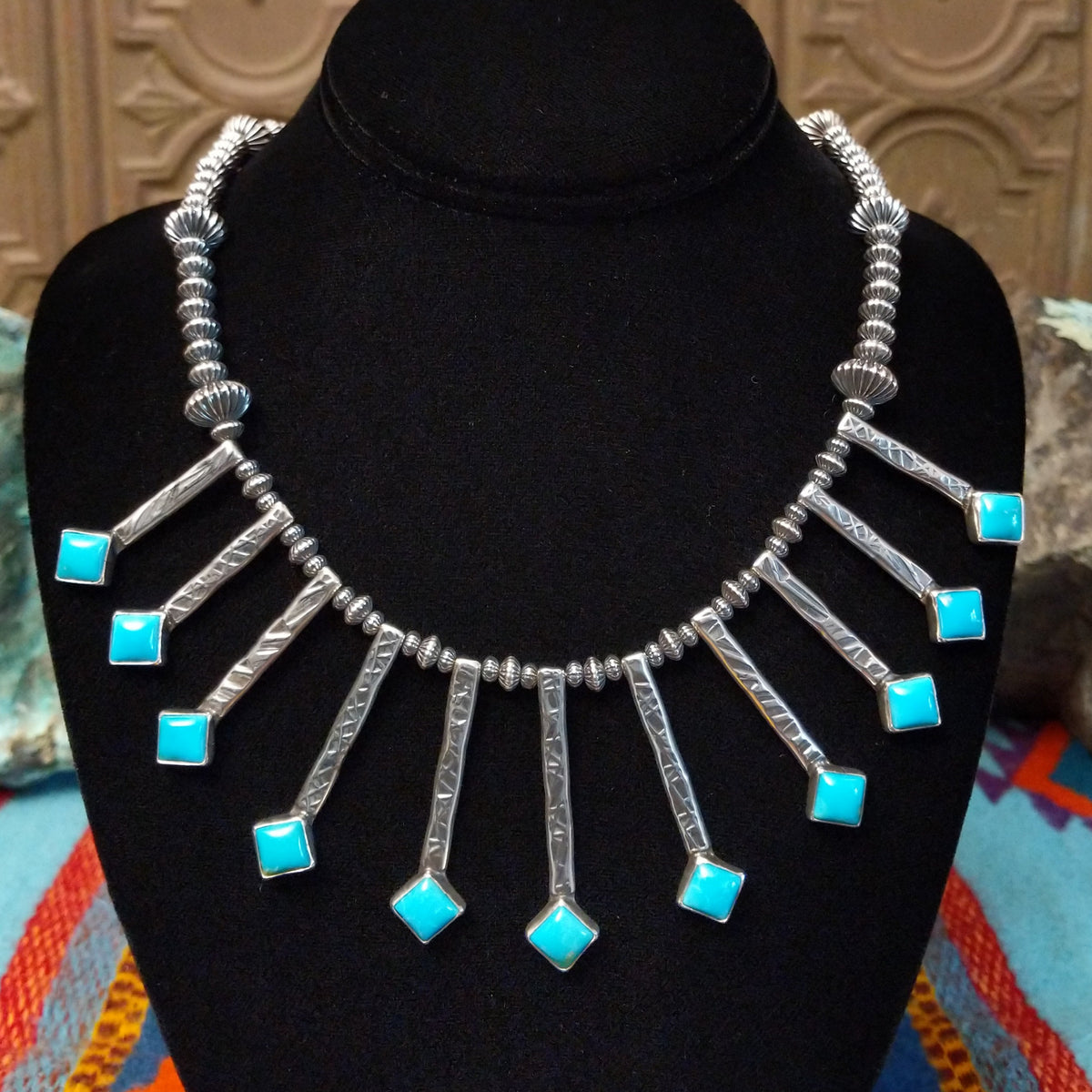 Everett & Mary Teller Kingman Turquoise necklace featuring vibrant turquoise stones, stamped Sterling Silver drops, and decorative silver beads.