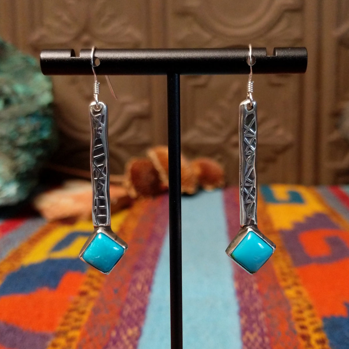 Everett & Mary Teller Kingman Turquoise earrings featuring vibrant turquoise stones, stamped Sterling Silver drops, and decorative silver beads.